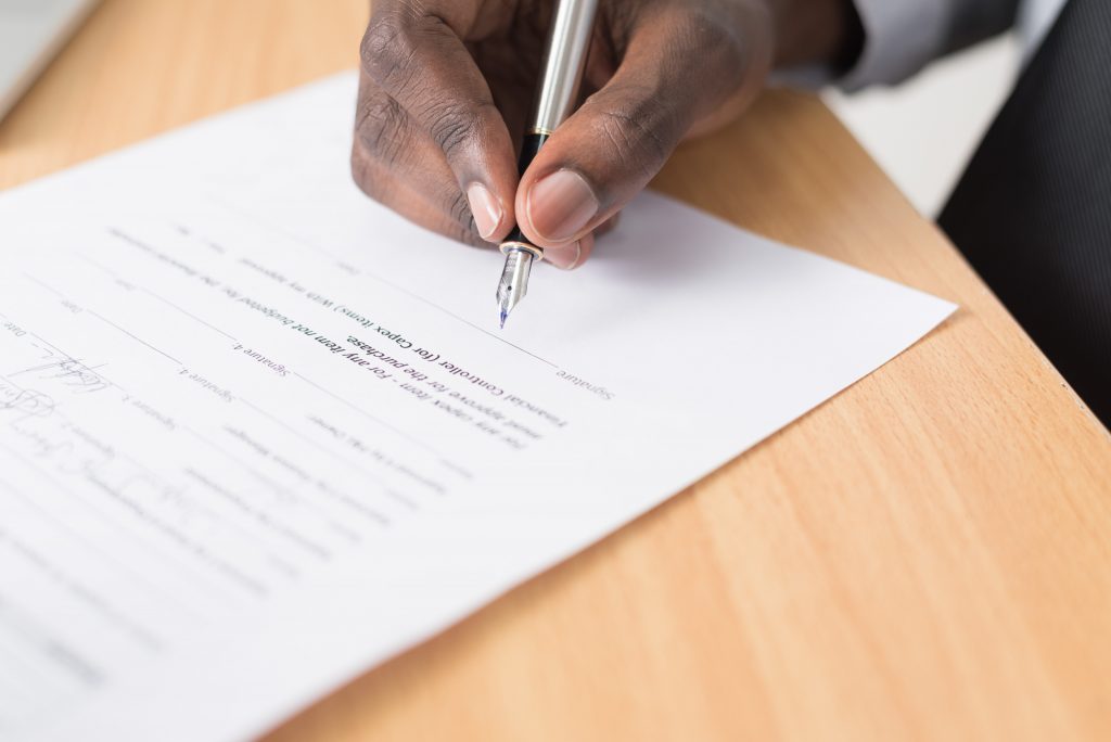 businessman signing a document in a contract dispute case
