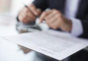 Shallow dof image of a businessman signing the contract