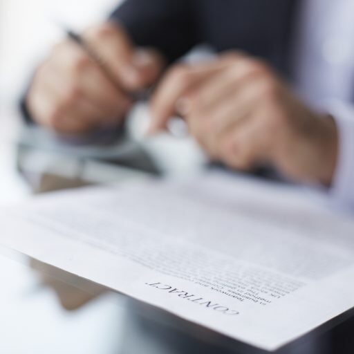 Shallow dof image of a businessman signing the contract